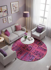 6' x 6' Round Pink & Purple Distressed Patchwork Bohemian Area Rug styled in a cozy living room seating area.