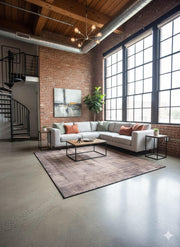 6' x 6' Square Brown Beige Distressed Solid Modern Area Rug styled in a contemporary loft living room featuring a subtle distressed texture and warm brown and beige tones.