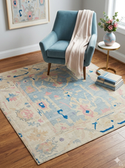 6' x 6' Square Ivory & Blue Tribal Medallion Traditional Area Rug styled in a reading nook with a blue accent chair and side table.