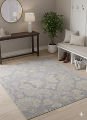 6' x 6' square blue, ivory, and gray tonal damask transitional area rug styled in an entryway with a console table, round mirror, and neutral seating bench.