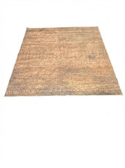 6' x 6' square brown & beige with subtle gray tones distressed modern washable area rug placed in a cozy room with natural lighting.