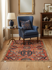 6' x 6' square rust orange & blue floral medallion traditional area rug placed in a cozy reading nook with a blue armchair, side table, and warm neutral decor.