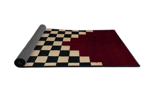 6' x 9' Abstract Dark Almond Brown Modern Area Rug rolled corner view revealing the flexible backing and neatly finished edges.