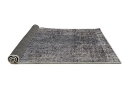 6' x 9' Mid-Century Modern Dark Gray Oriental Area Rug rolled corner perspective revealing the flexible backing and neatly finished edges.