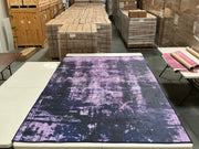 6' x 9' Rectangular Black & Purple Distressed Abstract Modern Washable Area Rug featuring irregular purple textured patterns against a dark black background, displayed in product view.