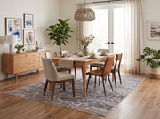 6' x 9' Rectangular Blue Beige Distressed Geometric Tribal Southwestern Area Rug styled in a modern dining room with a rectangular wooden dining table, upholstered dining chairs, and a woven pendant light.