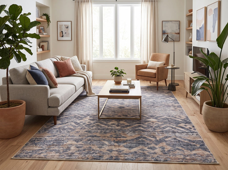 6' x 9' Rectangular Blue Beige Distressed Geometric Tribal Southwestern Area Rug styled in a modern living room with a light gray sofa, wooden coffee table, tan accent chair, and indoor plants.