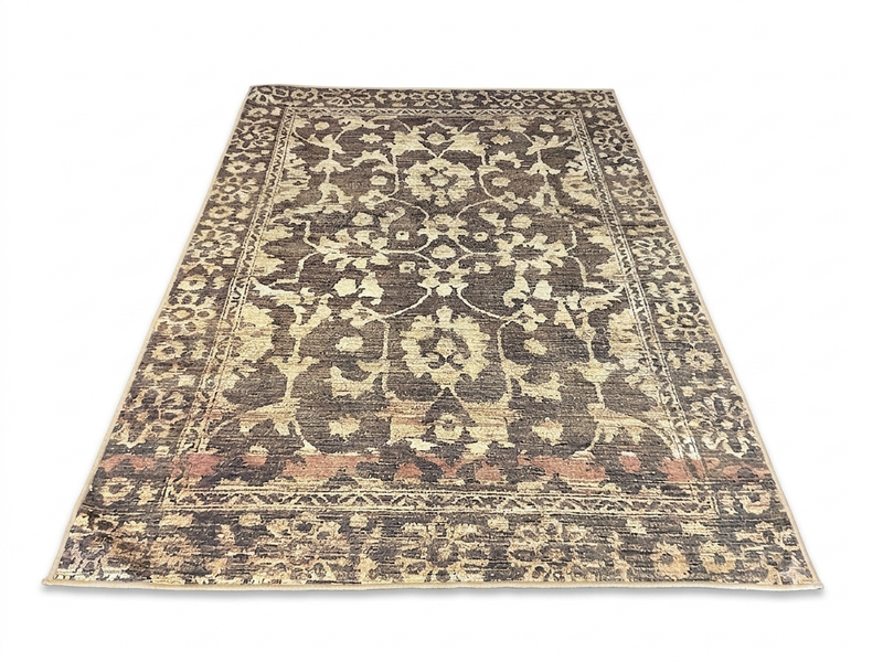 6' x 9' Rectangular Brown Beige Floral Traditional Washable Area Rug displayed in an angled product view on a white background, showcasing its intricate floral pattern, ornate border, and distressed brown and beige details.