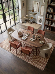 6' x 9' Rectangular Brown Ivory Checkered Geometric Modern Washable Area Rug styled in a dining room with an oval wooden dining table and rust-colored upholstered chairs.