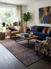 6' x 9' Rectangular Brown Navy Crackled Geometric Modern Area Rug styled in a living room with a navy blue sofa, tan leather armchair, and rectangular wooden coffee table.