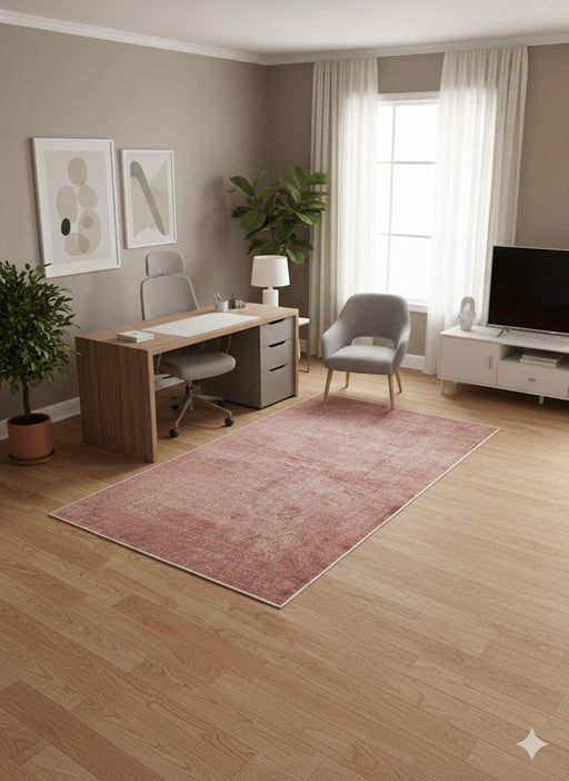 6' x 9' Rectangular Dusty Rose & Soft Brown Distressed Solid Traditional Area Rug placed in a modern home office setting.