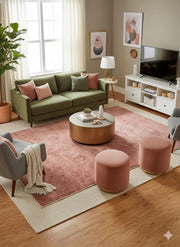 6' x 9' Rectangular Dusty Rose & Soft Brown Distressed Solid Traditional Area Rug placed / styled in a bright modern living room layered over a neutral base rug.