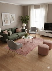 6' x 9' Rectangular Dusty Rose & Soft Brown Distressed Solid Traditional Area Rug placed / styled in a cozy contemporary living room with green sofa and accent chairs.