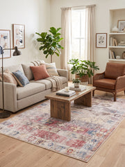 6' x 9' Rectangular Ivory Pink Distressed Geometric Tribal Bohemian Area Rug styled in a living room with a beige sofa and wooden coffee table.