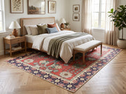 6' x 9' Rectangular Red Green Floral Medallion Traditional Area Rug placed in a bedroom with a wooden bed, white bedding, olive green blanket, and upholstered bench.