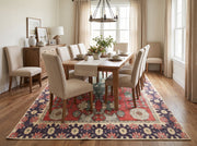 6' x 9' Rectangular Red Green Floral Medallion Traditional Area Rug styled in a dining room with a rectangular wooden dining table, cream upholstered chairs, and a wooden sideboard.