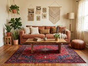 6' x 9' Rectangular Red Navy Floral Medallion Traditional Area Rug styled in a living room with a rust-colored sofa and wooden coffee table.