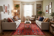 6' x 9' Rectangular Red Navy Tree Motif Traditional Area Rug styled in a living room with two beige sofas and a wooden coffee table.