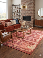 6' x 9' Rectangular Rust Pink Southwestern Tribal Geometric Area Rug featured in a living room with a sofa, coffee table, and brick fireplace backdrop.