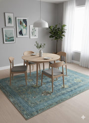 6' x 9' Rectangular Teal Blue & Sage Green Traditional Floral Medallion Washable Non-Slip Backing Area Rug placed under a round wooden dining table in a bright modern dining room.