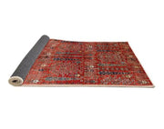 6' x 9' Red Mid-Century Modern Oriental Area Rug rolled corner perspective highlighting the flexible backing and finished edges.