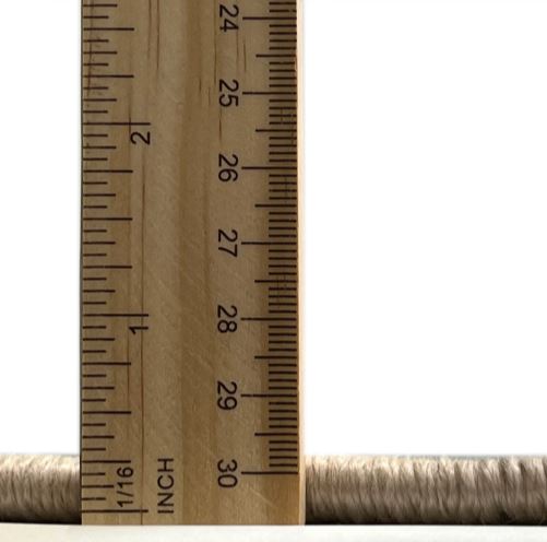 6' x 9' Red Mid-Century Modern Oriental Area Rug thickness measurement view showing the low-profile pile height beside a ruler for scale.