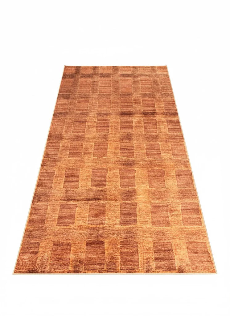 6' x 9' burnt orange rectangular area rug featuring a soft brown geometric block pattern with subtle textured detailing.