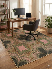6' x 9' multi-color botanical abstract rectangular area rug placed beneath a wooden desk in a bright home office setting.