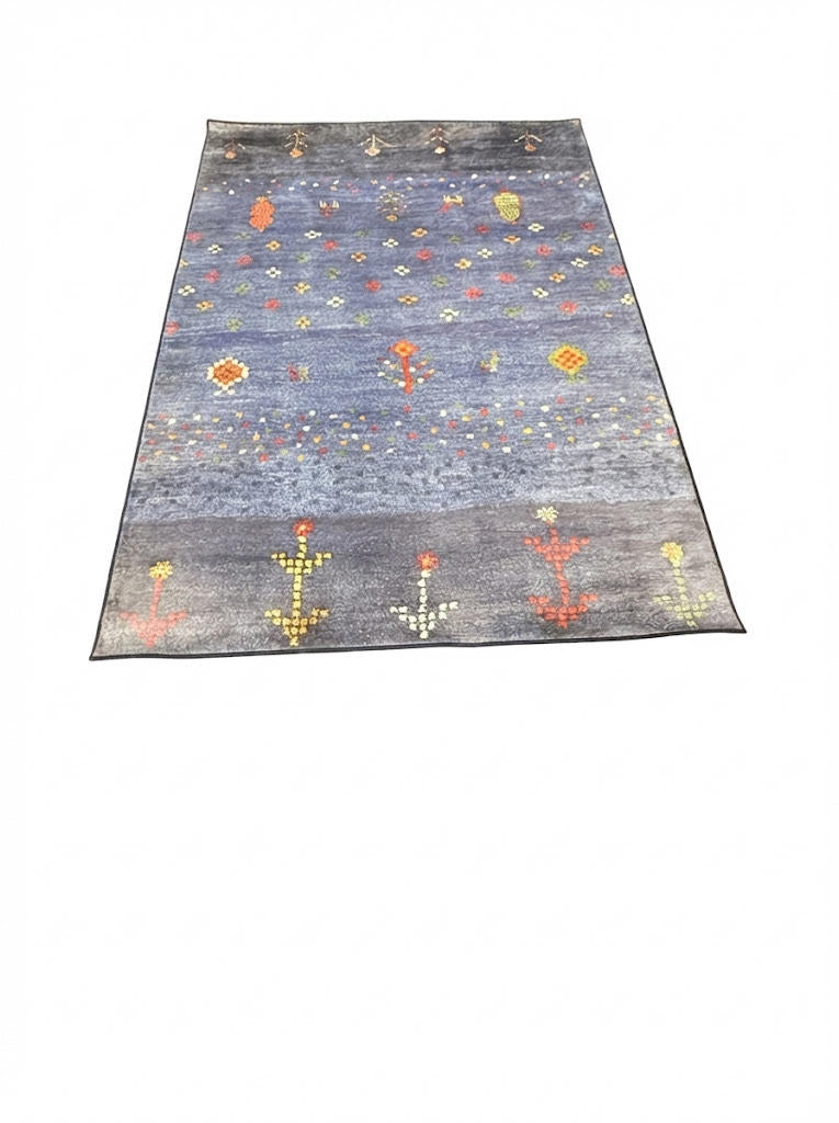 6' x 9' rectangular area rug featuring a blue background with scattered multi-color abstract geometric motifs in red, yellow, green, and cream.