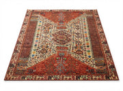 6' x 9' rectangular area rug featuring a multi-color tribal medallion traditional design in shades of red, cream, blue, and gold with a detailed border.