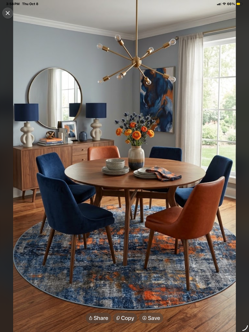 7' Round Navy Blue Orange Gray Distressed Abstract Modern Area Rug styled in a dining room with a round wooden dining table and blue and orange upholstered chairs.