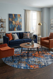 7' Round Navy Blue Orange Gray Distressed Abstract Modern Area Rug styled in a living room with a navy blue sofa and round wooden coffee table.