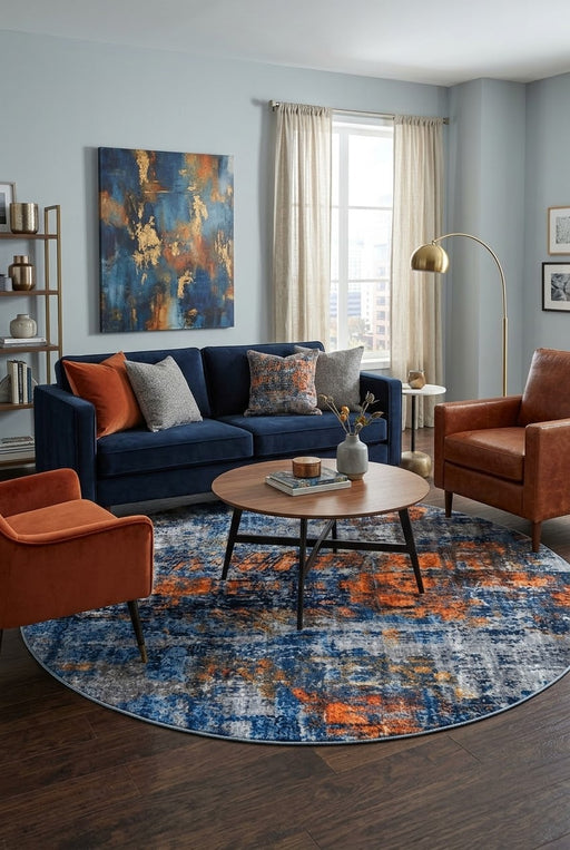 7' Round Navy Blue Orange Gray Distressed Abstract Modern Area Rug styled in a living room with a navy blue sofa and round wooden coffee table.