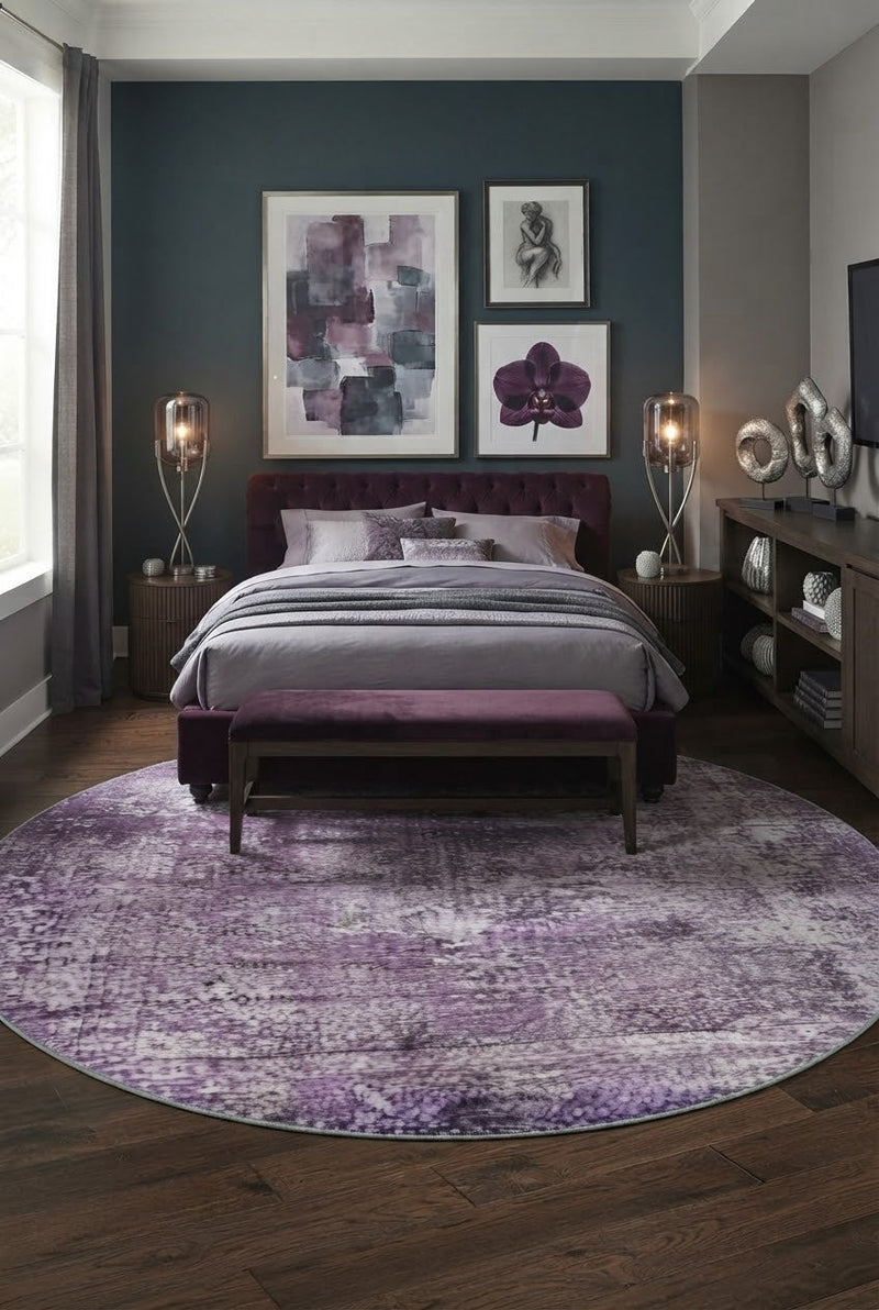 7' Round Purple Lavender Gray Distressed Abstract Modern Area Rug placed in a bedroom with a purple upholstered bed and matching bench.