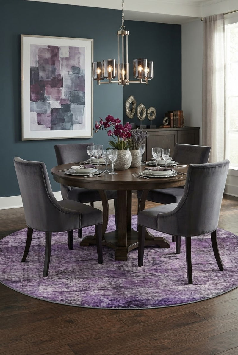 7' Round Purple Lavender Gray Distressed Abstract Modern Area Rug styled in a dining room with a round wooden dining table and gray upholstered chairs.