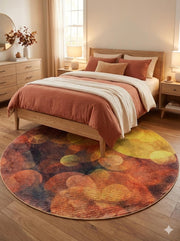 7 ft round abstract multi-color modern area rug placed partially under a bed in a warm bedroom with wood furniture and rust-toned bedding.