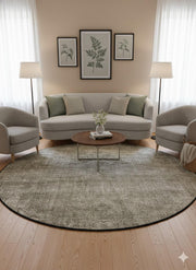 7' round beige, ivory, taupe, and gray heathered washable area rug styled in a neutral living room with a curved sofa, accent chairs, and light wood decor.