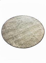 7' round washable area rug featuring a soft heathered texture in beige, ivory, taupe, and gray tones with a subtle dark trim border.