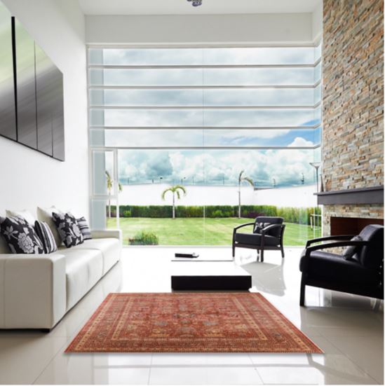 7' x 10' Mid-Century Modern Sunrise Orange Oriental Area Rug displayed in a bright contemporary living room, highlighting the warm sunrise orange tones and intricate traditional Oriental-inspired patterns.