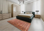7' x 10' Mid-Century Modern Sunrise Orange Oriental Area Rug styled in a modern bedroom setting, emphasizing the rich orange hues and elegant vintage-inspired pattern.