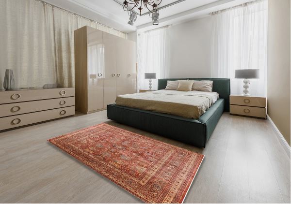7' x 10' Mid-Century Modern Sunrise Orange Oriental Area Rug styled in a modern bedroom setting, emphasizing the rich orange hues and elegant vintage-inspired pattern.