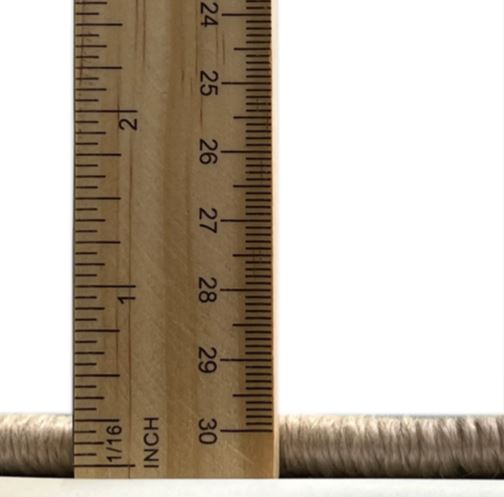 7' x 10' Mid-Century Modern Sunrise Orange Oriental Area Rug thickness measurement image displaying the low-profile pile height next to a ruler for scale.