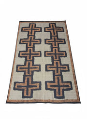 7' x 10' Rectangular Beige & Black Brown Cross Geometric Modern Southwestern Washable Area Rug featuring repeating cross motifs and a simple decorative border, displayed in product view.