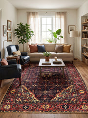 7' x 10' Rectangular Black & Burgundy Floral Medallion Traditional Oriental Area Rug styled in a living room with a beige sofa and black accent chairs.