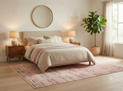 7' x 10' Rectangular Blush Pink Ivory Tribal Geometric Modern Southwestern Washable Area Rug styled in a bedroom with a beige upholstered bed and wooden nightstands.