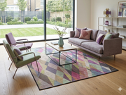 7' x 10' Rectangular Multicolor Geometric Abstract Modern Washable Area Rug styled in a living room with a gray sofa, colorful accent chairs, and wooden coffee table.