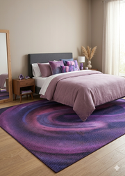 7' x 10' Rectangular Purple & Pink Abstract Modern Area Rug placed beneath a bed in a chic modern bedroom.