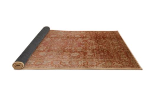 7' x 10' Rectangular Rust Mango Orange & Beige Floral Medallion Oriental Mid-Century Modern Area Rug partially rolled showing backing on a white background.