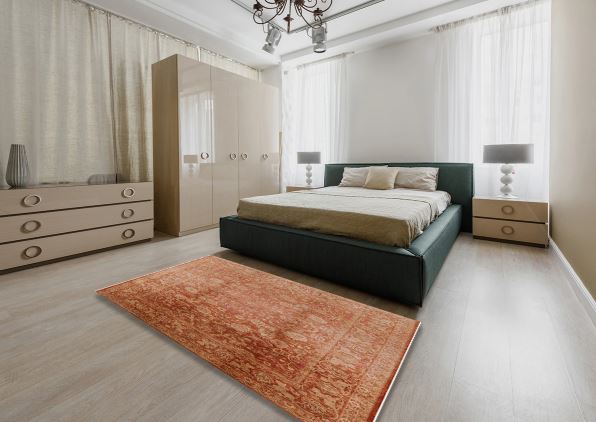 7' x 10' Rectangular Rust Mango Orange & Beige Floral Medallion Oriental Mid-Century Modern Area Rug styled in a modern bedroom.