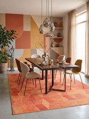 7' x 10' Rectangular Rust Orange Peach Abstract Geometric Modern Contemporary Area Rug styled in a dining room with a wooden dining table and upholstered chairs.